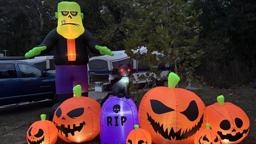 Inflatable Frankenstein standing over a row of jack-o-lanterns