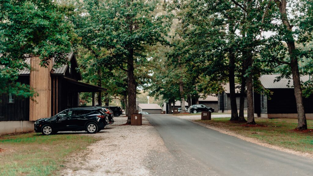 Cabins lining the paved road through the resort, with numbered sites and guest parking.