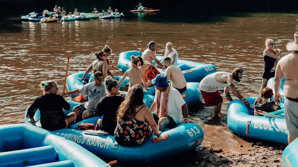 A group boarding Blue Springs Ranch rafts from the gravel bar.
