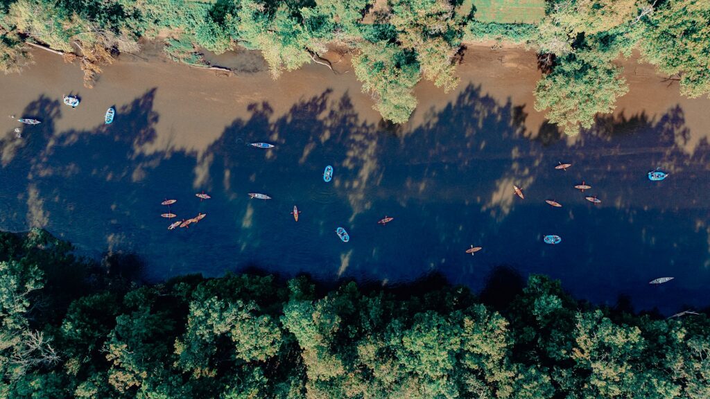 Kayaks and canoes seen directly from above on a busy float day.