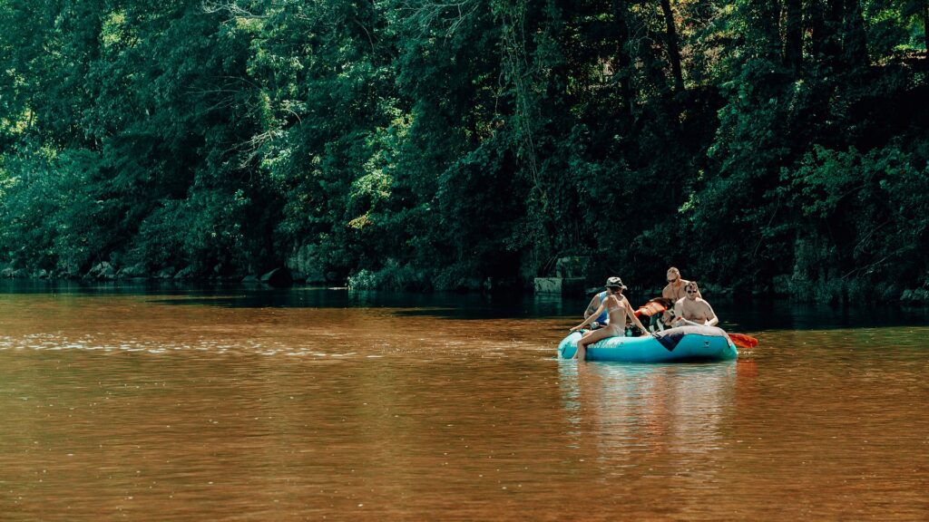 Four guests floating together in a raft down the Meramec.