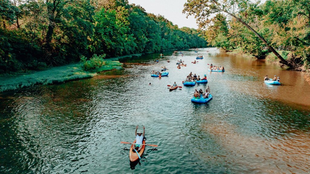 Rafts and kayaks passing a gravel bar, seen from the air.
