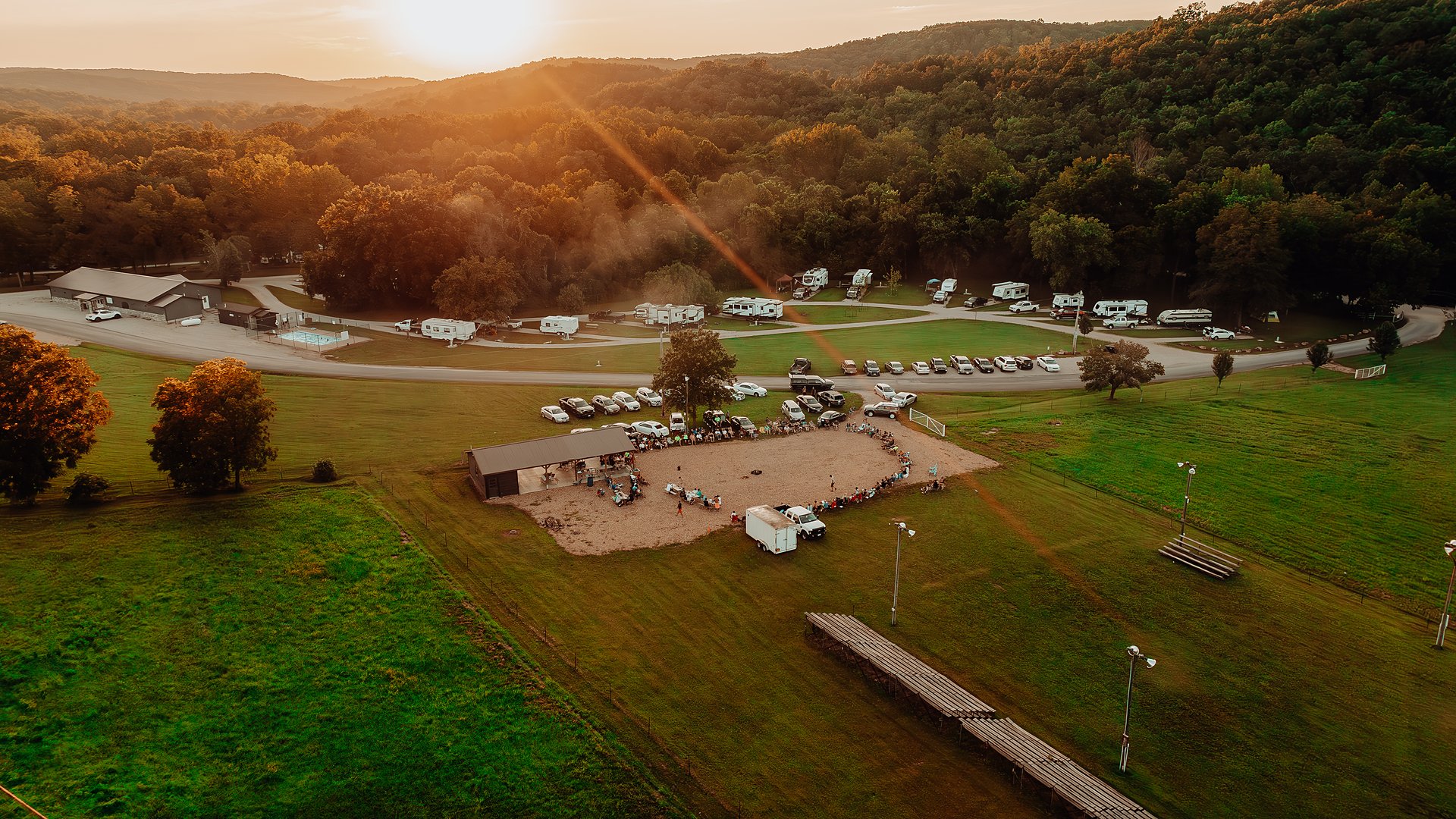 The resort from the air at sunset, the sun breaking over the ridge.