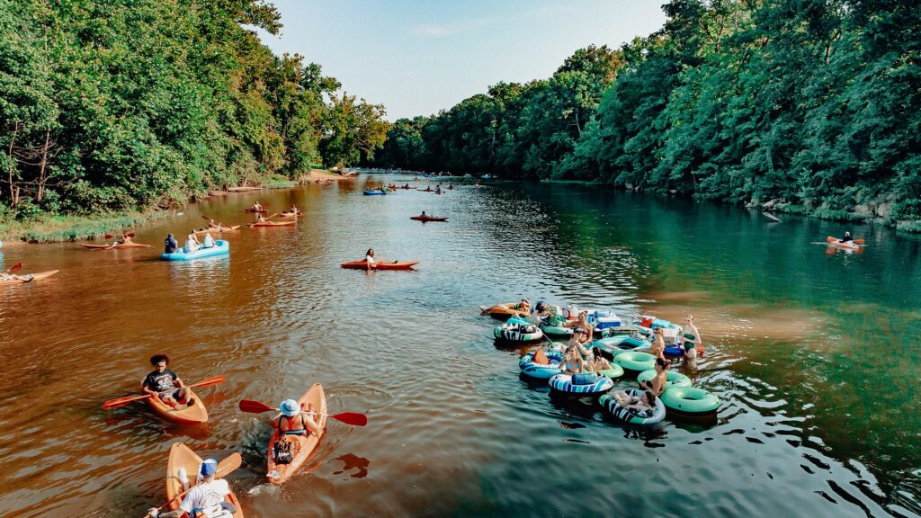 A flotilla of tubes and kayaks drifting together down the Meramec River.