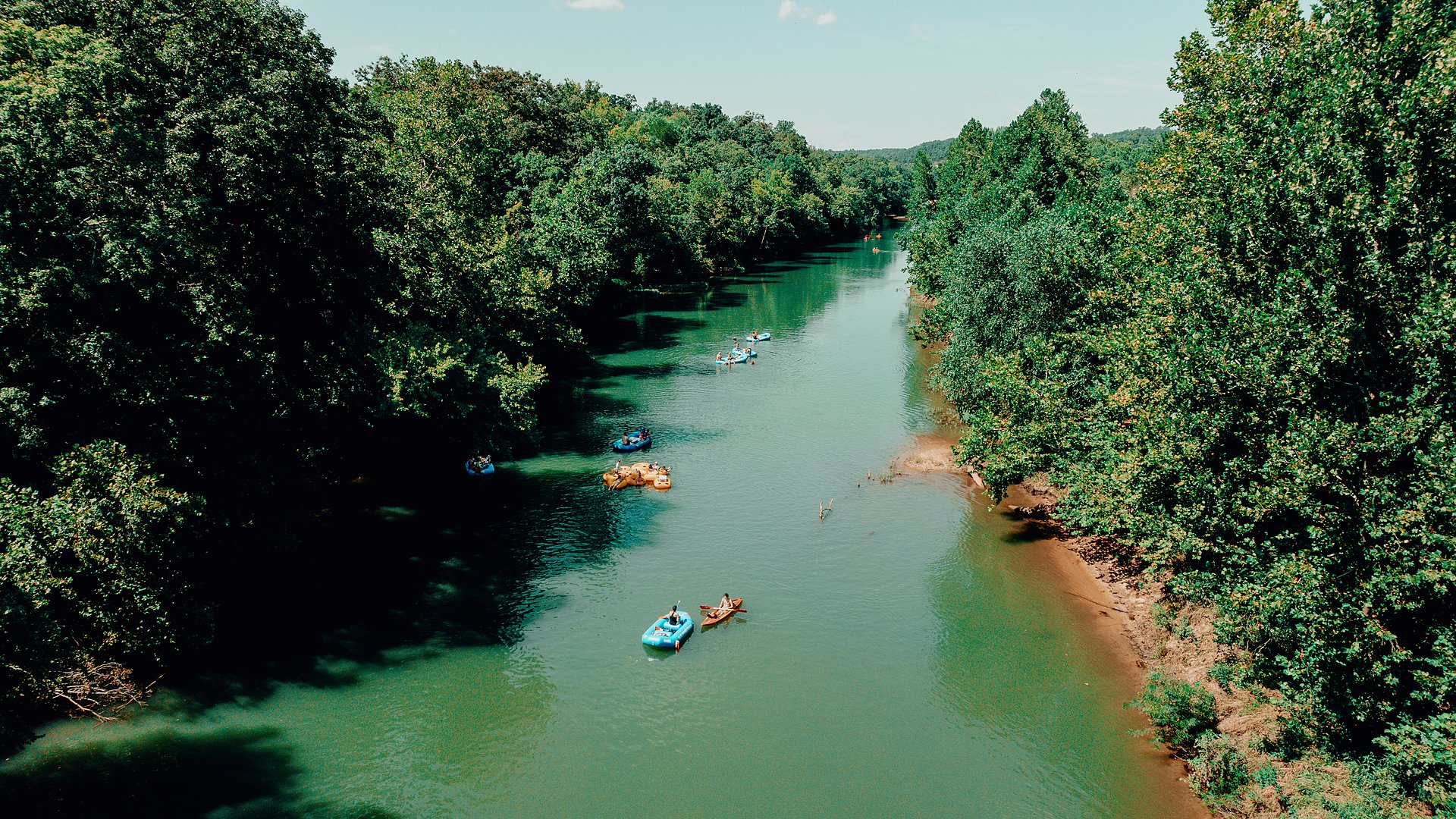 A wide, calm green stretch of the Meramec with a handful of floaters.
