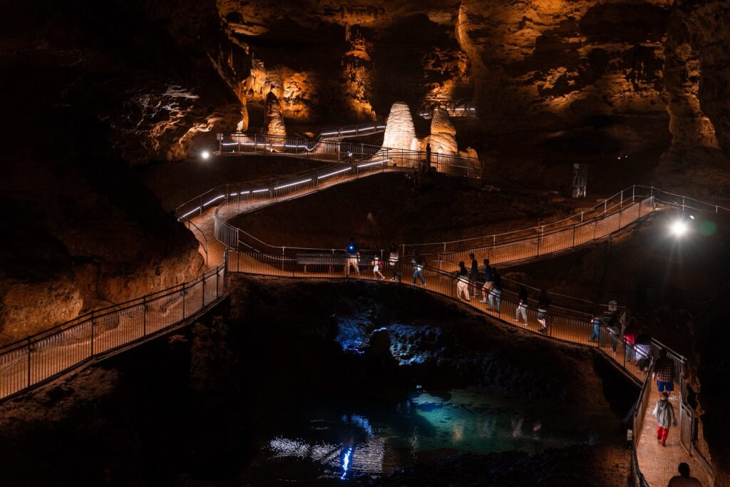 Lit boardwalk winding through a chamber of Onondaga Cave